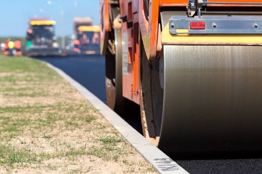 Roller compacting fresh asphalt on a commercial job