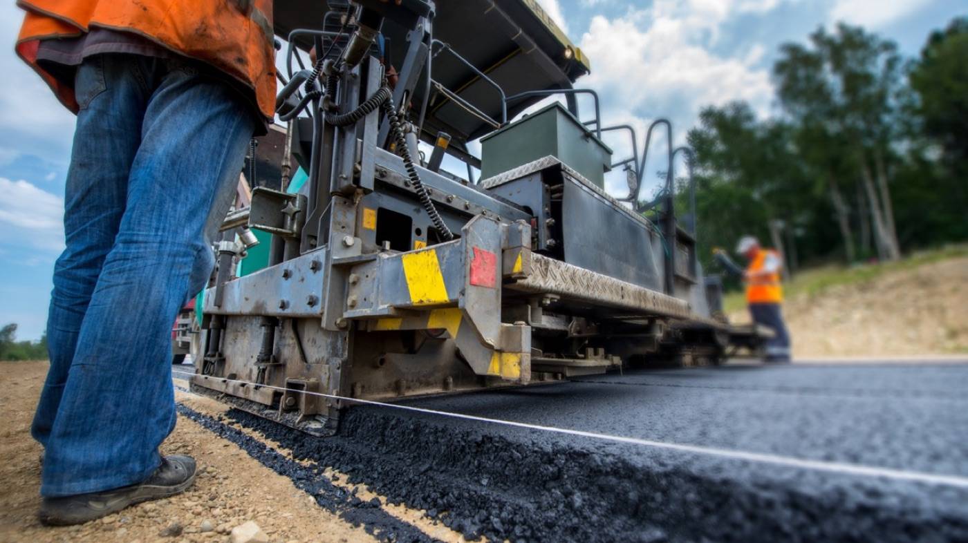 Pave It Forward crew paving with an asphalt paver